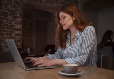 medium-shot-woman-with-laptop-coffee-shop